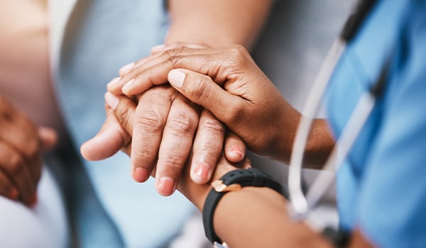 doctor holding patient hand