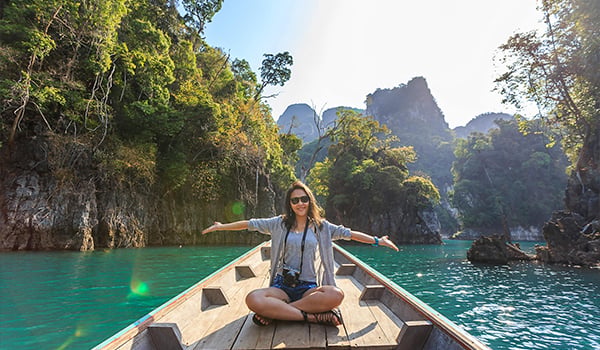 girl sitting on boat in tropical river