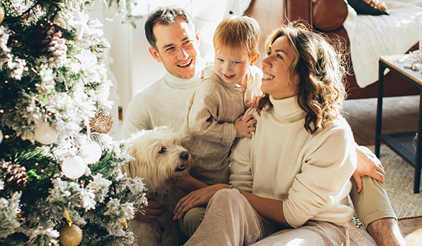 Happy family by christmas tree