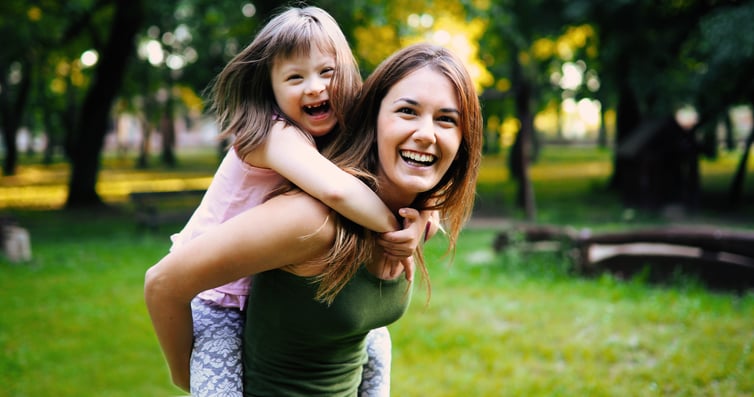 Mom playing with her daughter outside